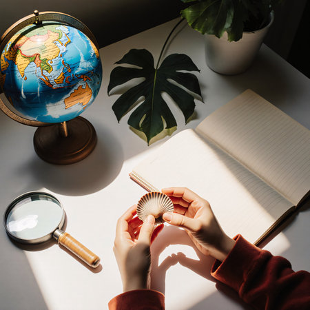 A child exploring seashells with notebook and magnifying glassの素材