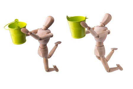 Wooden model of the person with a bucket in hands on the white isolated backgroundの写真素材