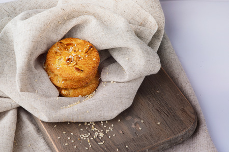 oatmeal cookies lay on a board covered with a cloth