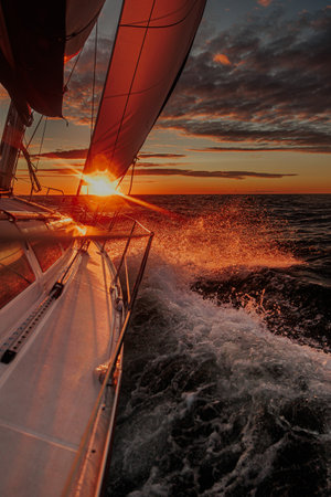 sailing yacht sailing at sunsetの写真素材