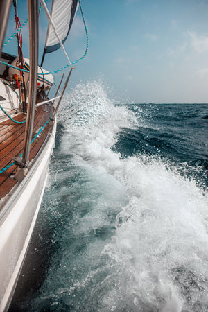 Sailing on a sailboat among big wavesの写真素材