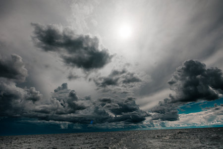 The dark sky with heavy clouds converging and a violent storm before the rain. Bad or moody weather...