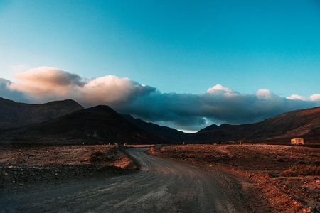 Volcanic landscapes of Lanzarote island. A road stretching into the distance. Panoramic birds-eye view of caves and cliffs, mountains.の写真素材