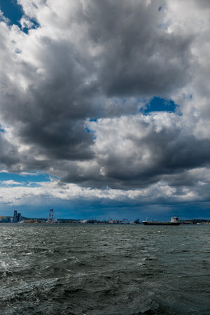 The dark sky with heavy clouds converging and a violent storm before the rain. Bad or moody weather sky and environment.の写真素材