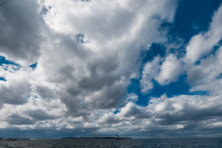 The dark sky with heavy clouds converging and a violent storm before the rain. Bad or moody weather sky and environment.の写真素材