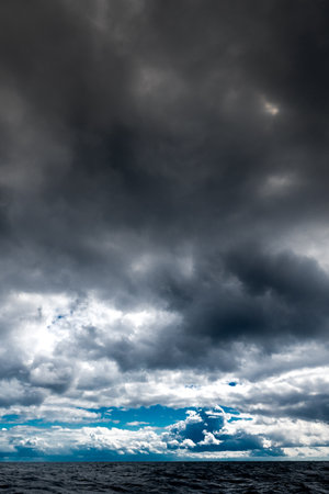 The dark sky with heavy clouds converging and a violent storm before the rain. Bad or moody weather...