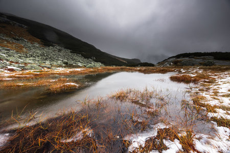 Beautiful mountain landscape with dramatic cloudy skyの写真素材
