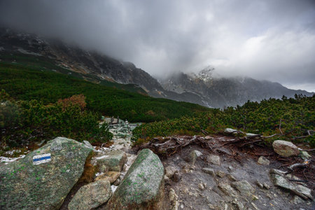 Beautiful mountain landscape with dramatic cloudy skyの写真素材