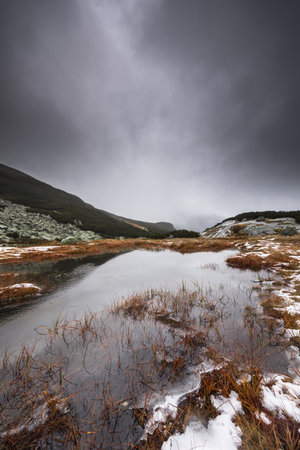 Beautiful mountain landscape with dramatic cloudy skyの写真素材