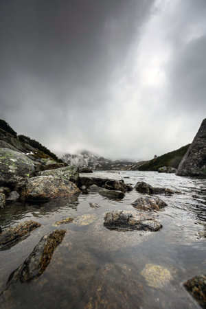 Beautiful mountain landscape with dramatic cloudy skyの写真素材