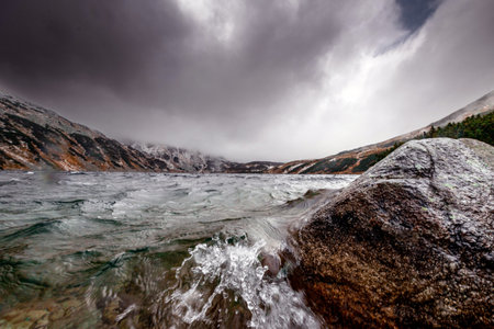 Beautiful mountain landscape with dramatic cloudy skyの写真素材