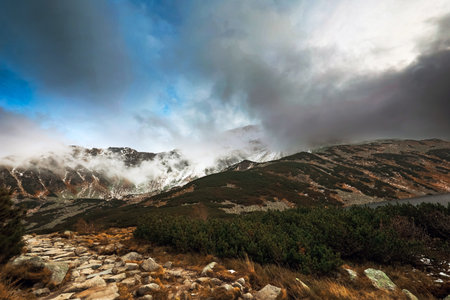 Beautiful mountain landscape with dramatic cloudy skyの写真素材