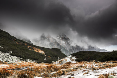 Beautiful mountain landscape with dramatic cloudy skyの写真素材
