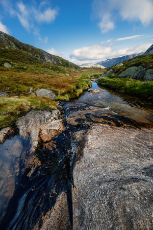 Beautiful mountain landscape with dramatic cloudy skyの写真素材