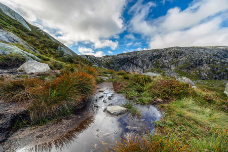 Beautiful mountain landscape with dramatic cloudy skyの写真素材