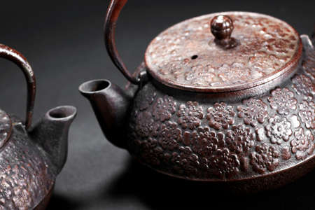 Iron teapot on black backgroundの写真素材