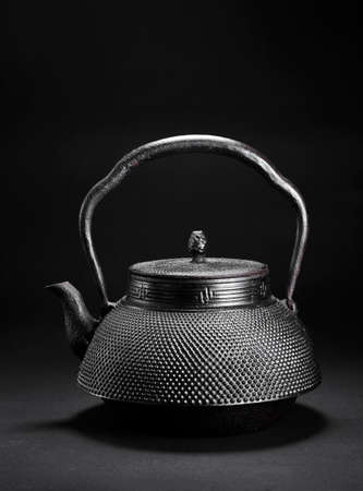Iron teapot on black backgroundの写真素材