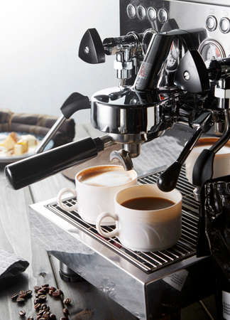 Two cup of coffee and coffee machinesの写真素材