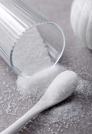 Closeup bowl and spoon with white sand on stone table backgroundの写真素材