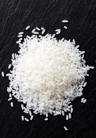 Closeup of  raw rice on stone plateの写真素材