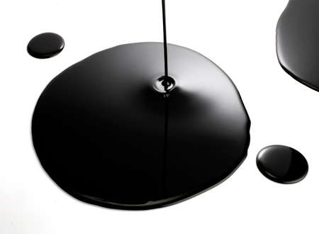 Closeup of Dark liquid on white background