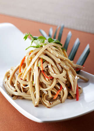 Udon stir-fried noodles with vegetables and herbs