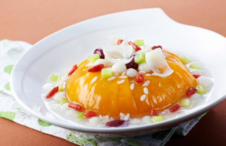 Pumpkin with rice and dried cranberries in a white plateの写真素材