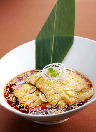 Dumplings with sesame seeds and soy sauce.