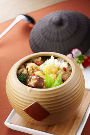 Chinese traditional food, steamed rice with vegetables in a wooden potの写真素材