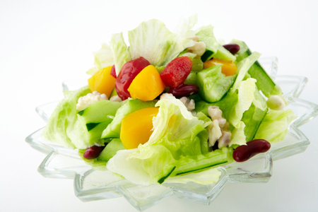 Fresh vegetable salad in glass bowl on white background. Healthy food concept.の写真素材