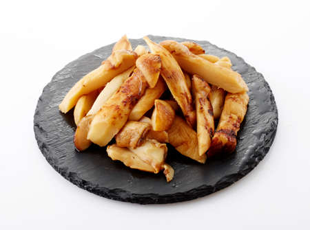 Fried on a black stone plate on a white background.の写真素材