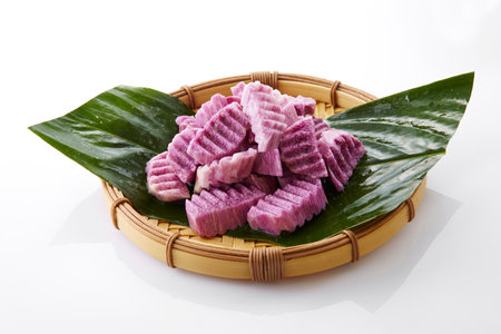 Sliced purple radish on bamboo sieve on white backgroundの写真素材