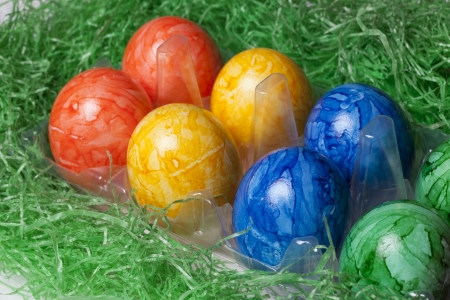 Plastic box with colored Easter eggsの写真素材