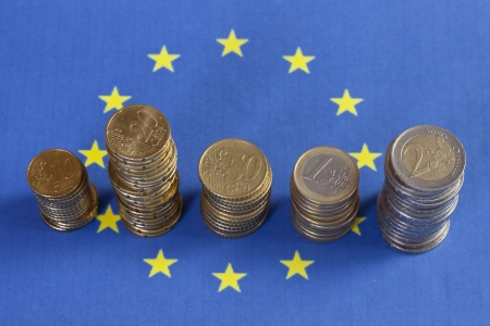 Euro Coins before EUR flagの写真素材