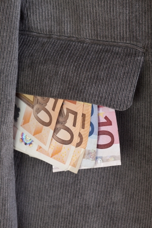 Euro bills stuck in the pocket of a jacketの写真素材