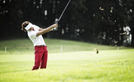 Woman pitching at golf course.の写真素材