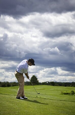 Golf player pitching.の写真素材