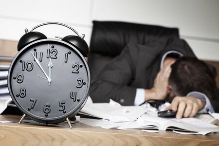 Depressed businessman down after receiving bad message.の写真素材