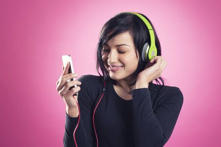 Happy girl listening to music with headphones.
