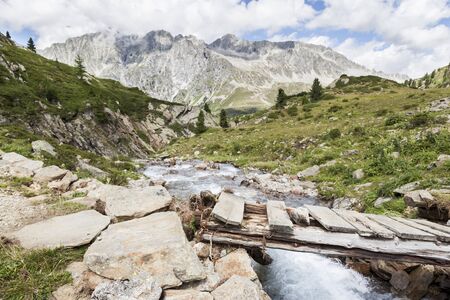 Bridge over mountain creek in Austrian/Italian Alps.