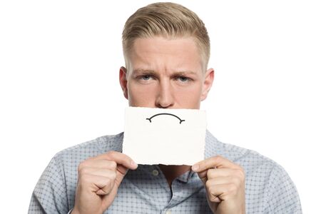 Upset businessman presenting blank white card.の写真素材
