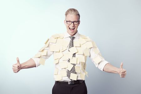 Joyful businessman with blank stickers attached to his shirt.の写真素材