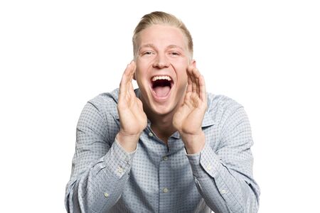 Excited young businessman shouting great news.の写真素材