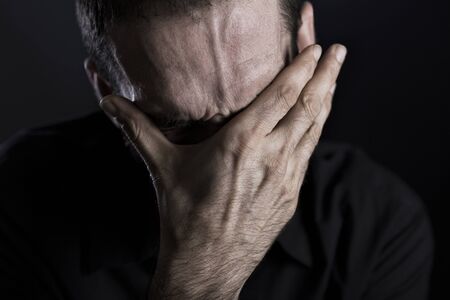 Close up of depressed and despaired man.の写真素材