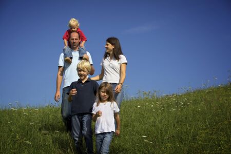 Family walking in fieldの写真素材