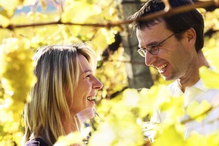 Happy couple tasting wineの写真素材