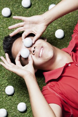 Gold player on floor with balls on eyes.の写真素材
