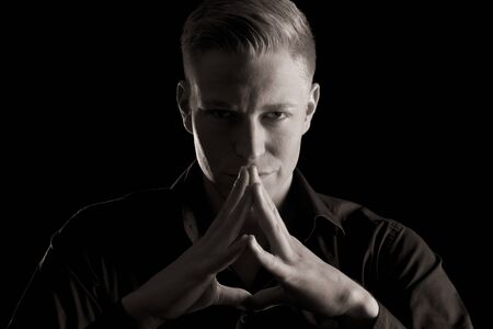 Low key portrait of young attractive man, black and white.の写真素材