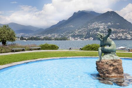 Lugano bay with statueの写真素材