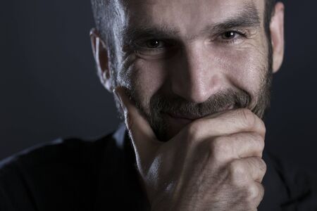 Close up of cheerful smiling man with warm look.